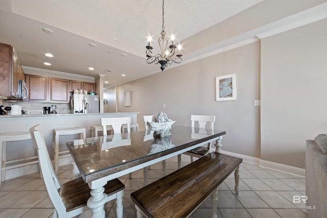 tiled dining space with a chandelier and ornamental molding