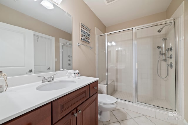bathroom featuring toilet, tile patterned floors, and a shower with shower door