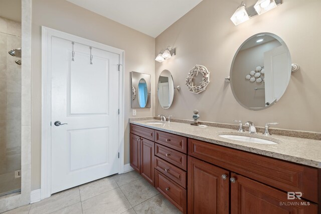 bathroom featuring vanity, tile patterned floors, and a shower with shower door