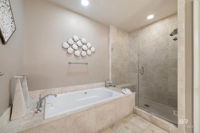 bathroom with tile patterned floors and independent shower and bath