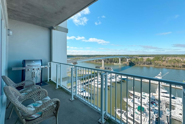 balcony with area for grilling and a water view