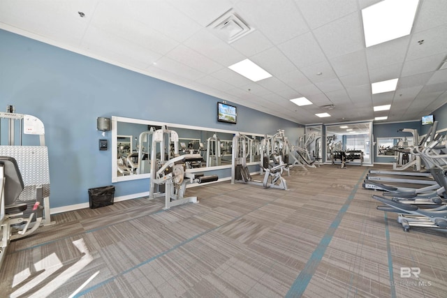 gym with carpet floors and a drop ceiling