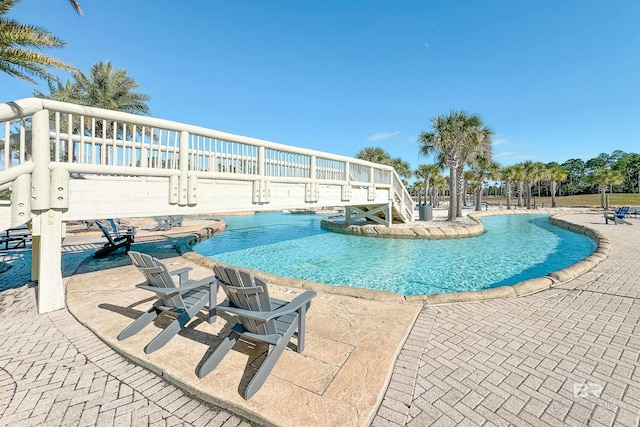 view of swimming pool featuring a patio area