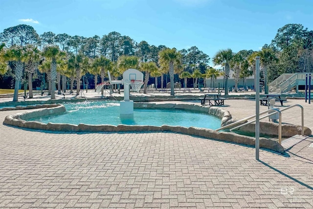 view of pool featuring basketball court