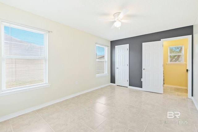 unfurnished bedroom featuring ceiling fan, a closet, and light tile patterned floors