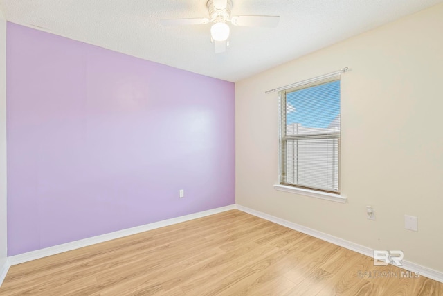 unfurnished room with light hardwood / wood-style flooring, ceiling fan, and a textured ceiling