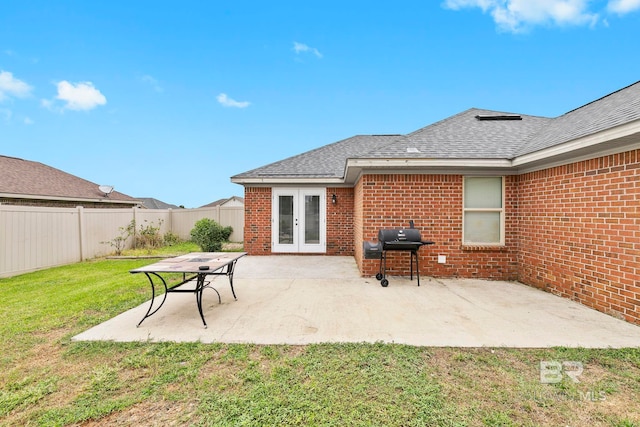 back of property with a yard and a patio area