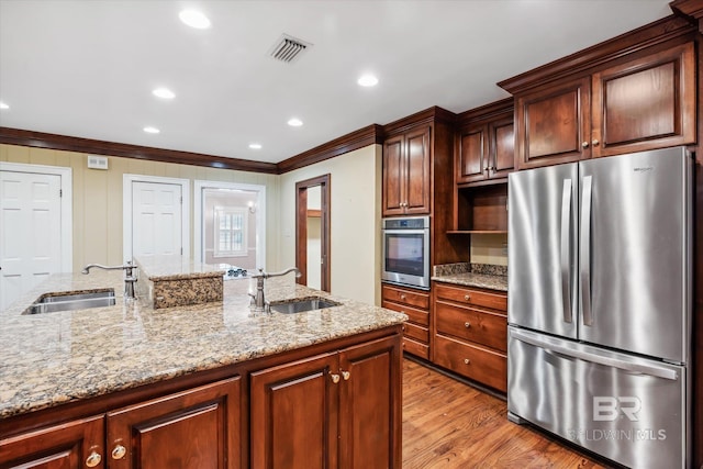 kitchen with crown molding, sink, light hardwood / wood-style flooring, and appliances with stainless steel finishes