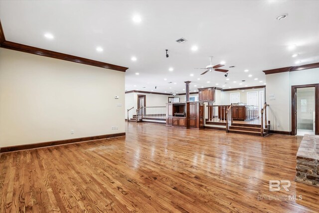 unfurnished living room featuring crown molding, ceiling fan, and hardwood / wood-style flooring