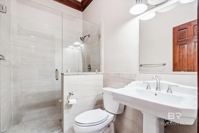 bathroom featuring sink, toilet, tile walls, and walk in shower