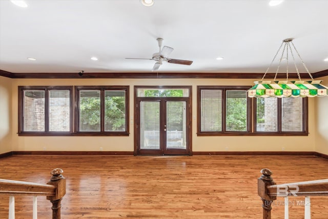 interior space featuring french doors, hardwood / wood-style flooring, ceiling fan, and crown molding