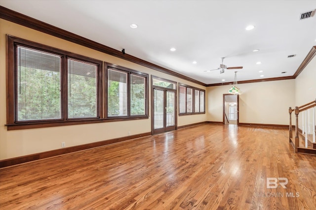 unfurnished living room featuring light hardwood / wood-style flooring, ceiling fan, and crown molding