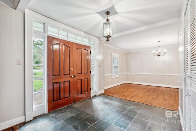 foyer with dark hardwood / wood-style flooring, a chandelier, and ornamental molding