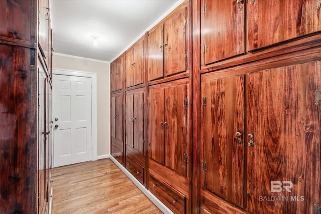 mudroom with ornamental molding and light hardwood / wood-style flooring