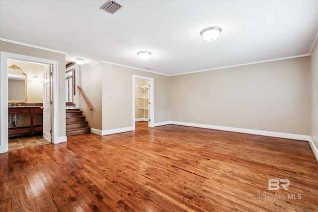 interior space featuring crown molding and wood-type flooring