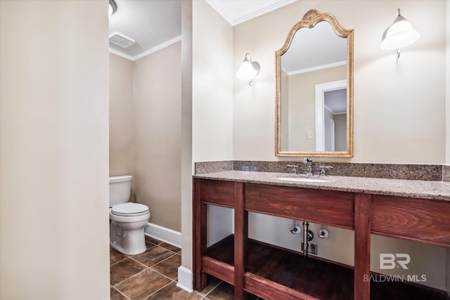 bathroom with toilet, crown molding, and sink