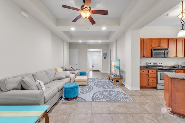1430 Regency Rd Unit G101, Gulf Shores, AL 36542 - living room with a tray ceiling, a ceiling fan, and light tile patterned flooring