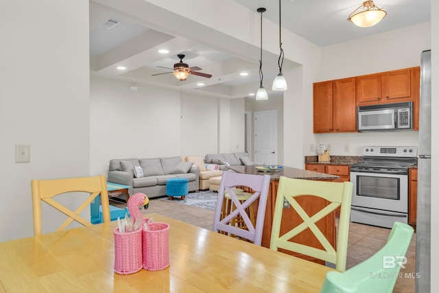 1430 Regency Rd Unit G101, Gulf Shores, AL 36542 - kitchen featuring stainless steel appliances, ceiling fan, brown cabinetry, recessed lighting, and decorative light fixtures