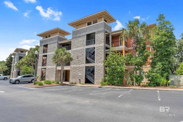 1430 Regency Rd Unit G101, Gulf Shores, AL 36542 - view of apartment building / complex featuring uncovered parking and stairway