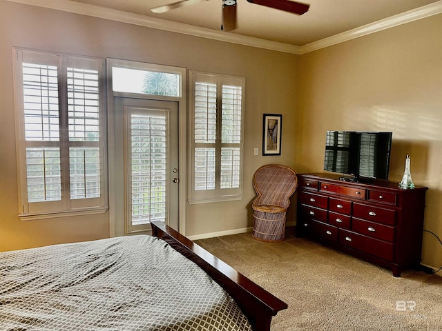 carpeted bedroom featuring ceiling fan and crown molding