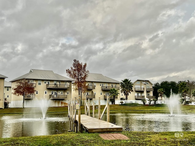 dock area featuring a lawn and a water view