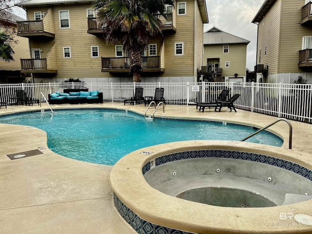 view of pool with a hot tub