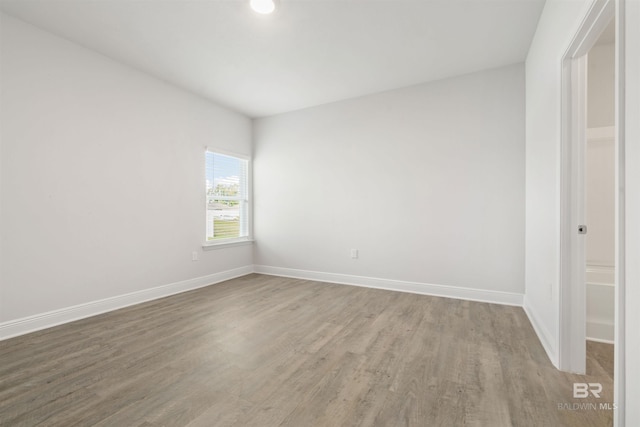 empty room with hardwood / wood-style flooring