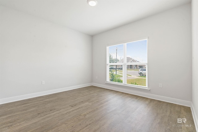 unfurnished room with wood-type flooring