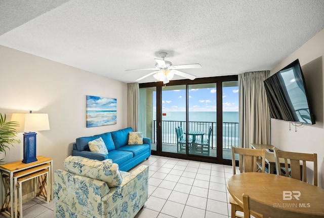 533 W Beach Blvd Unit 602, Gulf Shores, AL 36542 - living room featuring a textured ceiling, a ceiling fan, and light tile patterned floors