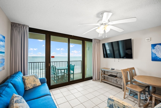 533 W Beach Blvd Unit 602, Gulf Shores, AL 36542 - living room with ceiling fan, tile patterned flooring, and a textured ceiling
