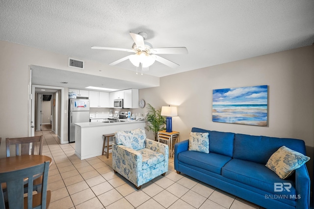 533 W Beach Blvd Unit 602, Gulf Shores, AL 36542 - living area featuring ceiling fan, visible vents, a textured ceiling, and light tile patterned floors