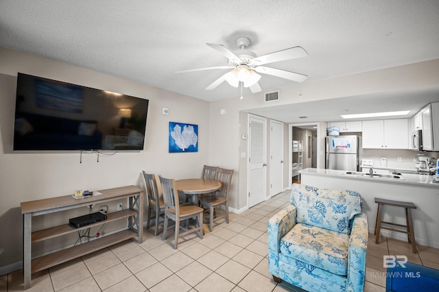 533 W Beach Blvd Unit 602, Gulf Shores, AL 36542 - living area featuring a textured ceiling, visible vents, ceiling fan, and light tile patterned floors
