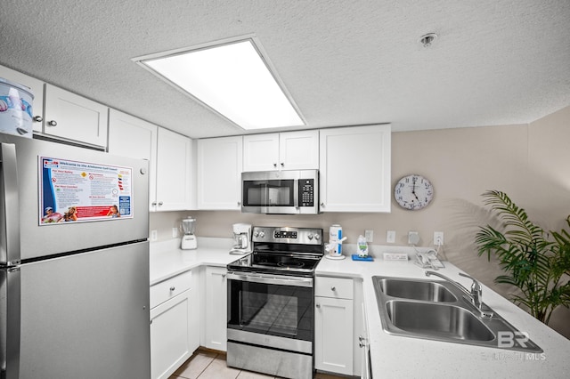 533 W Beach Blvd Unit 602, Gulf Shores, AL 36542 - kitchen with light countertops, appliances with stainless steel finishes, white cabinetry, and a sink