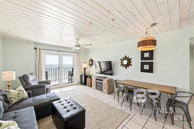 living area featuring wood ceiling, a ceiling fan, french doors, and light tile patterned floors