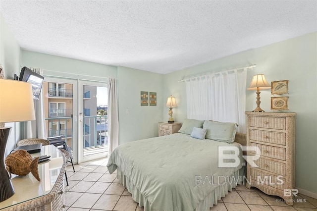 bedroom with light tile patterned flooring, french doors, access to exterior, and a textured ceiling