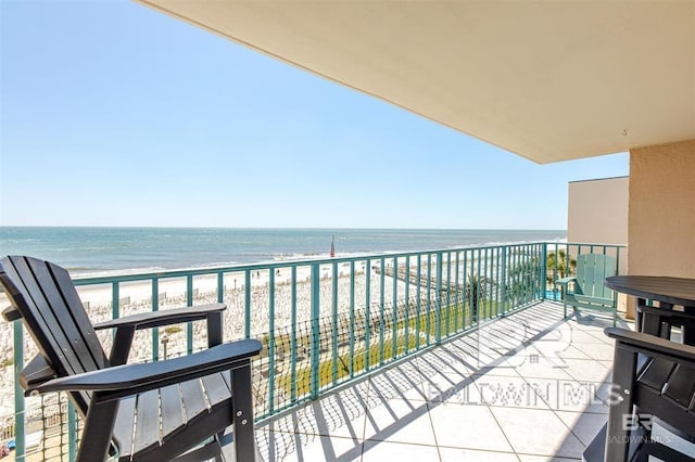balcony featuring a view of the beach and a water view