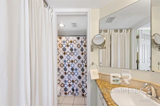 full bath with visible vents, toilet, vanity, and tile patterned floors