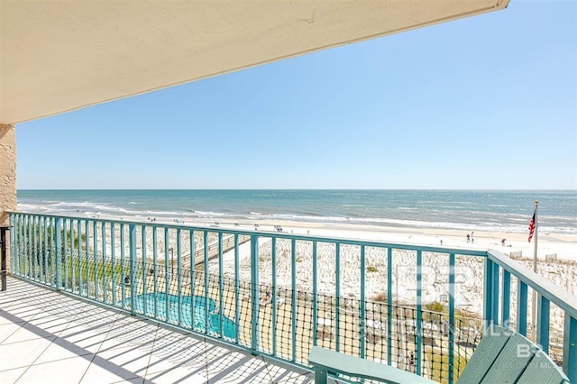balcony with a view of the beach and a water view