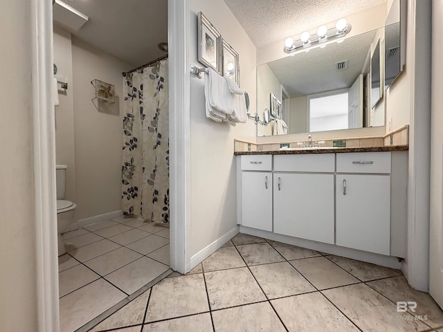 full bathroom featuring a textured ceiling, vanity, toilet, tile patterned flooring, and visible vents