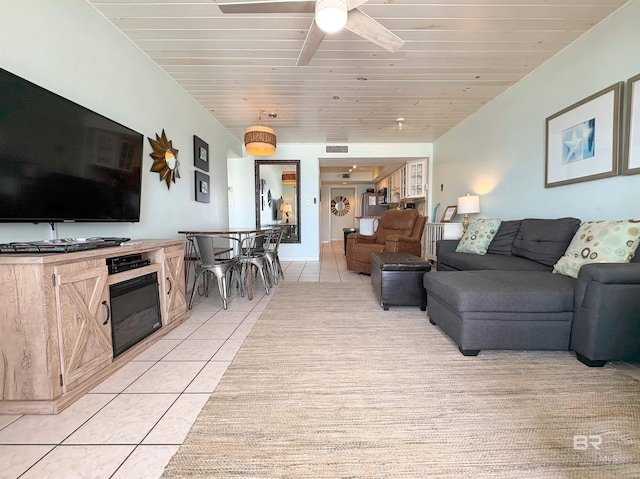 living room featuring ceiling fan, visible vents, and light tile patterned floors