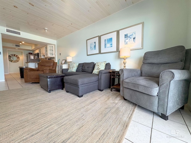 living area with wood ceiling, visible vents, and light tile patterned floors