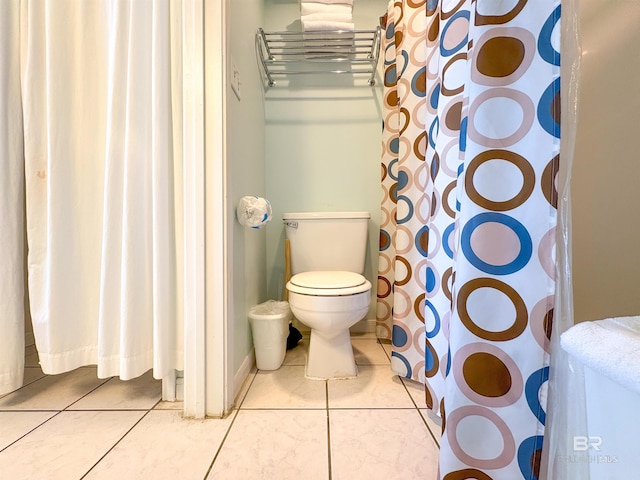 full bath with toilet and tile patterned floors
