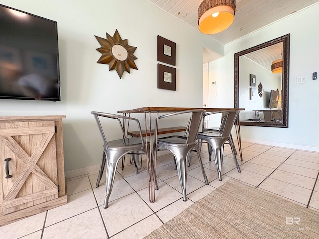 dining area with wood ceiling, baseboards, and light tile patterned flooring