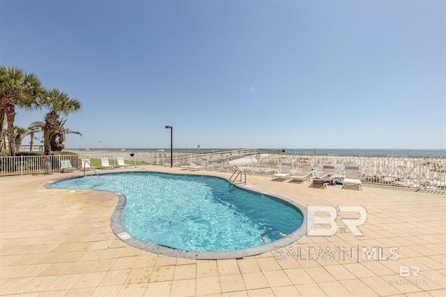 pool featuring a patio and fence