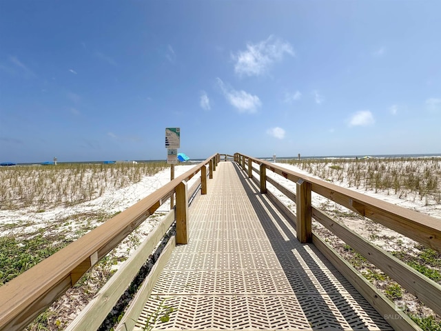 view of dock with a view of the beach and a water view