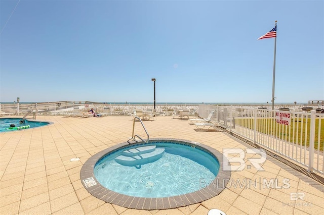 community pool featuring a patio and fence