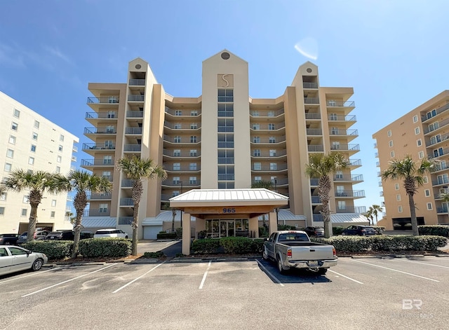 view of building exterior with uncovered parking