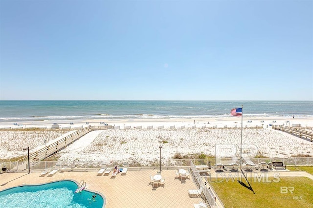 property view of water with a beach view and fence