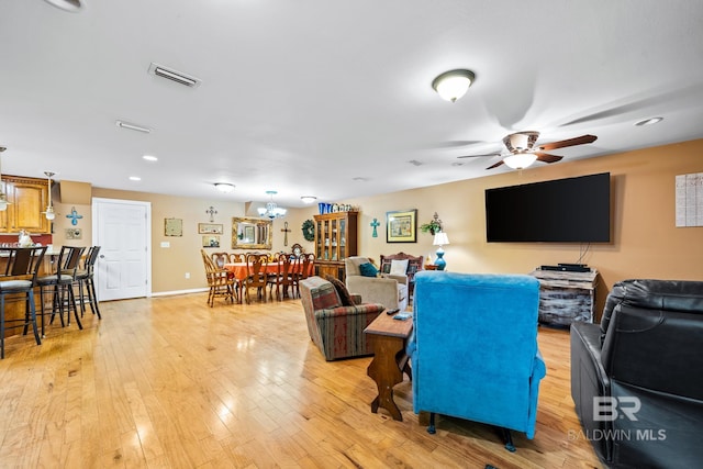 living room featuring ceiling fan and hardwood / wood-style flooring