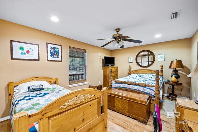 bedroom with light hardwood / wood-style flooring and ceiling fan